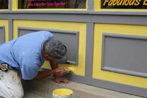 Man painting wall panels